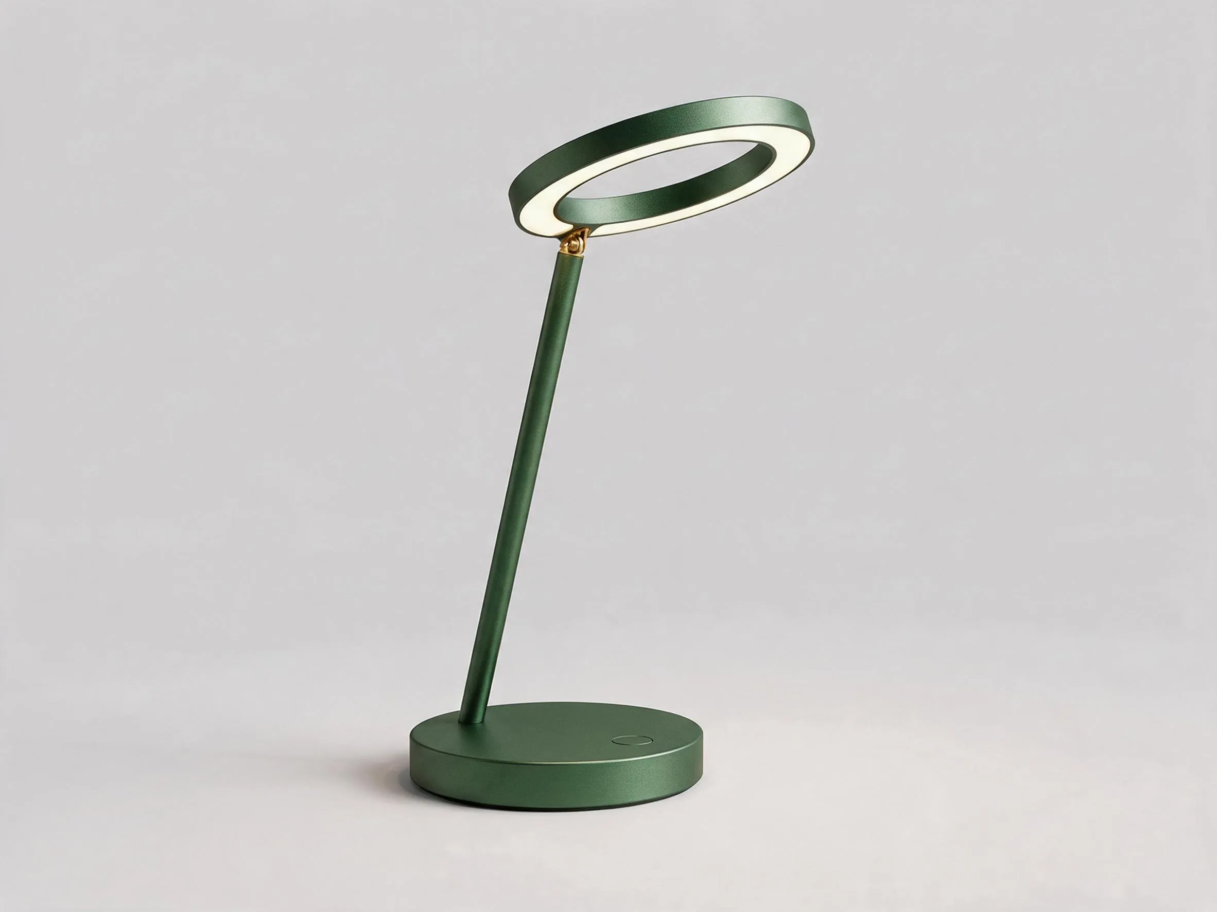 The Halo lamp in anodised forest green with a brass hinge.