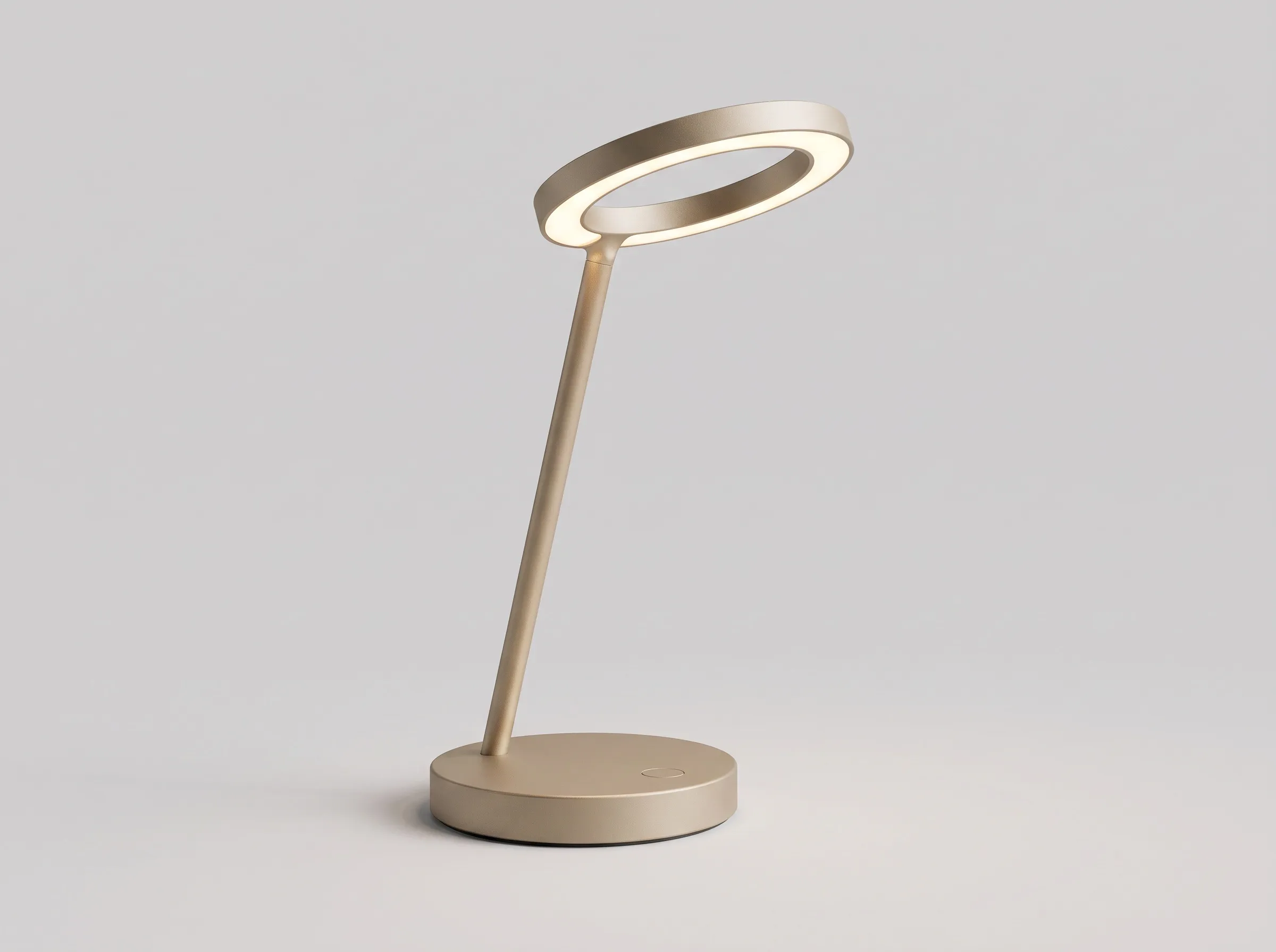 A photoreal render of the Halo lamp in sand-coloured aluminium, its ring glowing warm white, on a light grey studio backdrop.